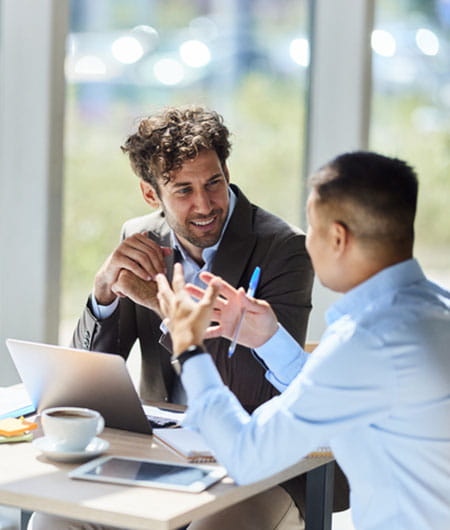 Two people sitting at a table in discussion