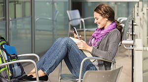 Woman sitting and looking at a smartphone