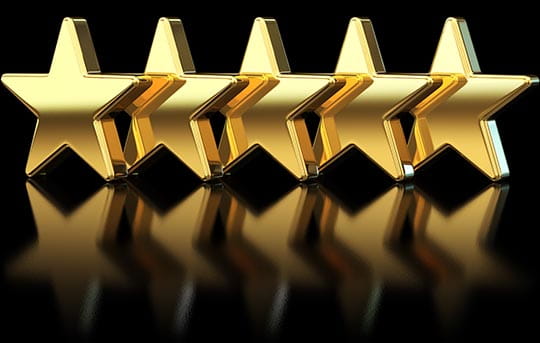 Image of 5 gold stars on a black reflective background