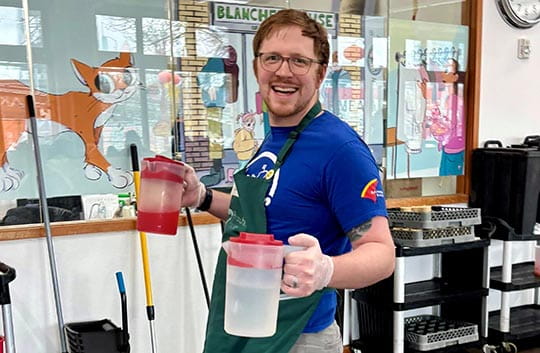 Banner employee carrying pitchers of drinks