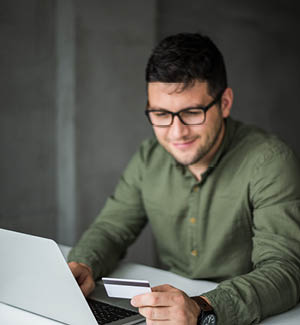 Business man on his computer looking at his card