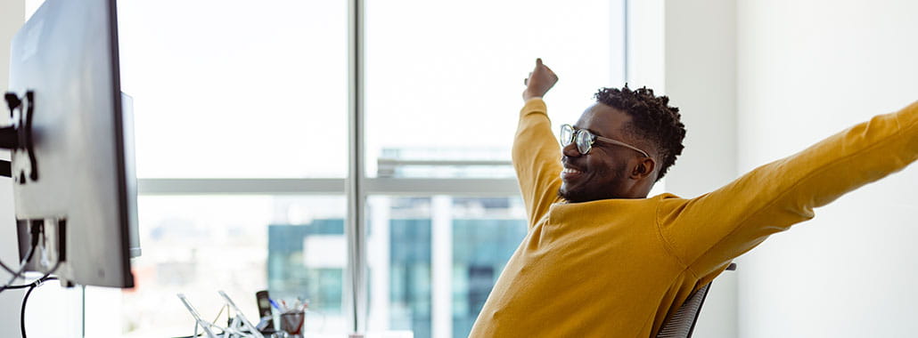 Person with arms in the air in an office