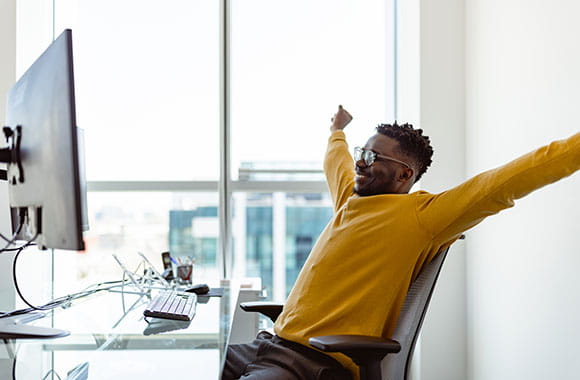 Person with arms in the air in an office