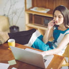 Woman uses laptop to view her business accounts from one convenient dashboard within Banner Online Banking