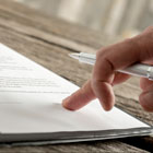 Close-up view of person looking at terms and conditions for online banking, bill pay, mobile banking, credit cards and debit cards