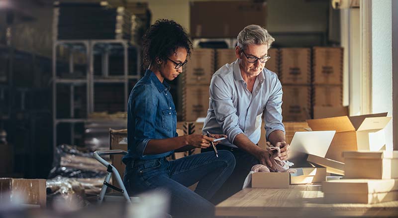 Colleagues looking at finances in workshop