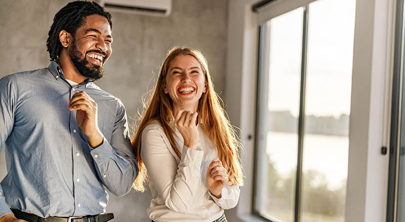 Two people dancing in office