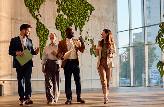 Colleagues walking and talking in lobby