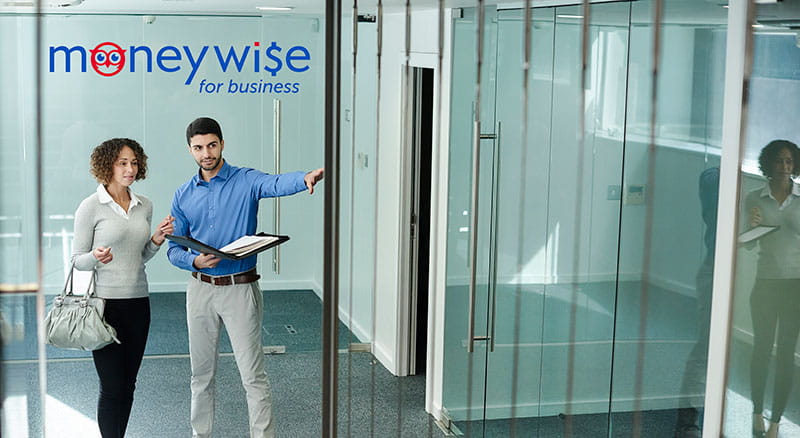 Two people looking at an empty office space