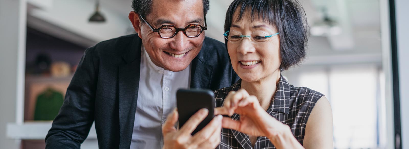 Smiling couple looks at phone