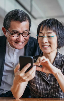 Smiling couple looks at phone