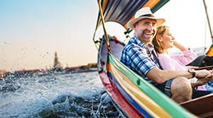 Couple in a colorful small boat on the water