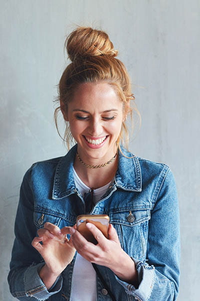 Person smiling while using cell phone