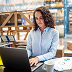 women working on her computer in a shop