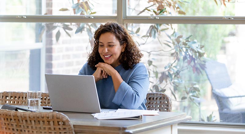 Person looking at laptop from kitchen table