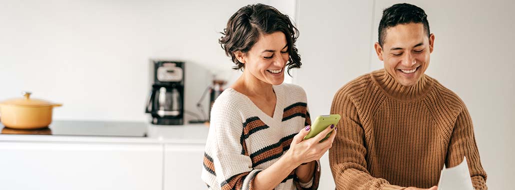 Couple looking at phone while smiling