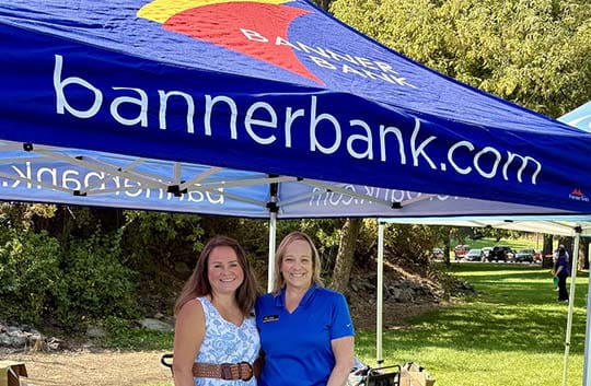 Employees in a Banner booth at a volunteer event