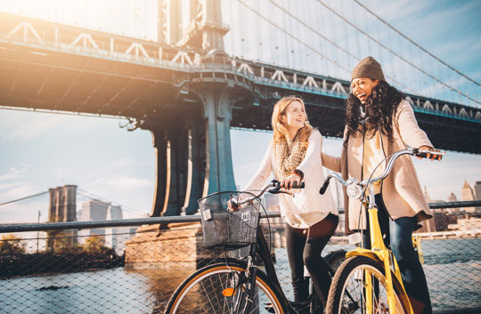Two bikers pause at Brooklyn Bridge in New York City