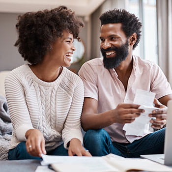 Two people looking at receipts and smiling