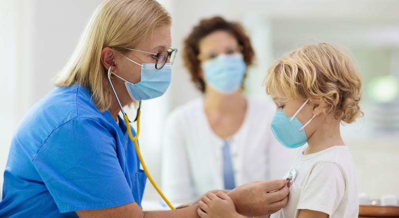 Nurse taking vitals of child
