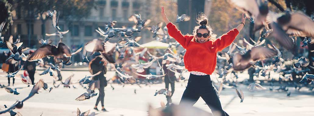 Person jumping while birds fly