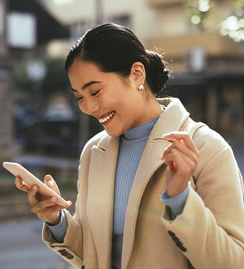 Person looking at phone and smiling