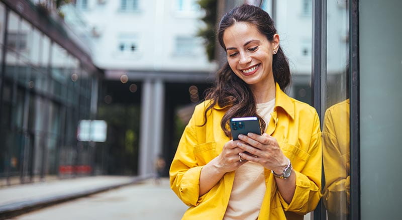 person smiling at cell phone
