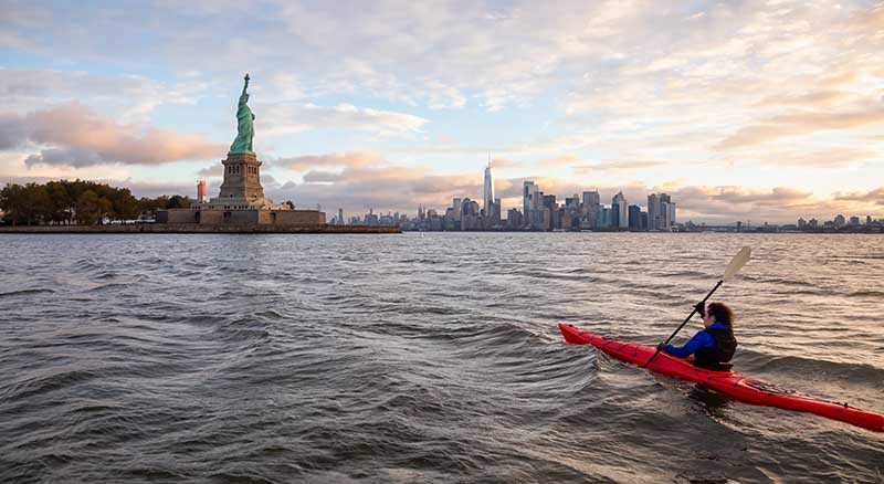 Person kayaking to Statue of Liberty in New York