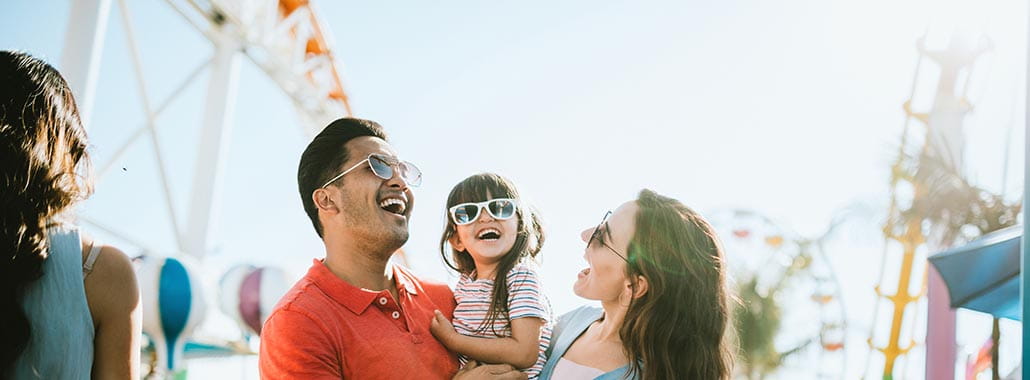 Family smiling at amusement park