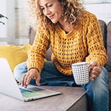 Woman at computer with a mug