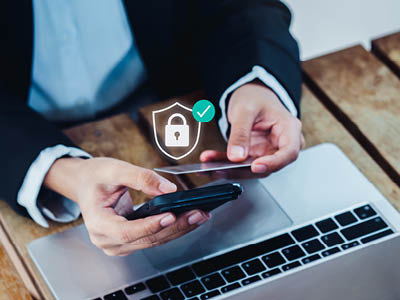 man at his computer with a lock icon overlapping picture