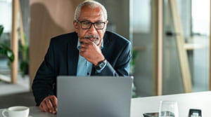 Person looking at laptop in office